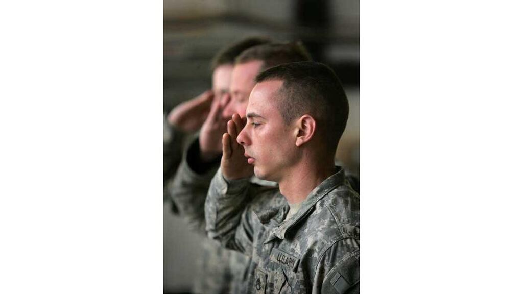 American soldiers pay their respects during the memorial service
for US army private Collin Schockmel, who was killed in Anbar
province last week.