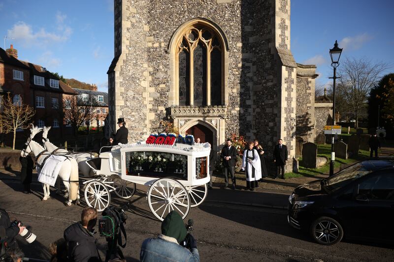 A white horse drawn hearse carrying the coffin of former One Direction singer Liam Payne arrives at a church in Amersham, Buckinghamshire. Photograph: Dan Kitwood/Getty Images