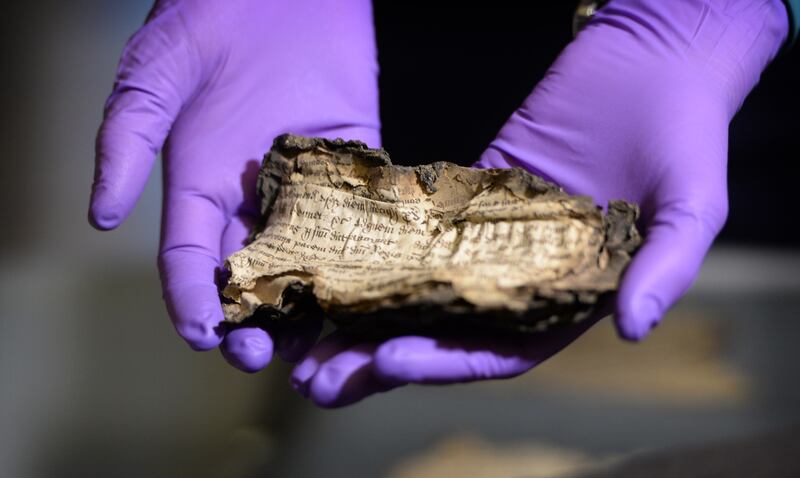 Zoe Reid, senior conservator with the National Archive of Ireland, holds a Henry Vlll Plea roll, at the launch of Beyond 2022: Ireland's Virtual Record Treasury research project in Decemeber 2019. Photograph: Dara Mac Dónaill/The Irish Times
Photograph: Dara Mac Donaill / The Irish Times