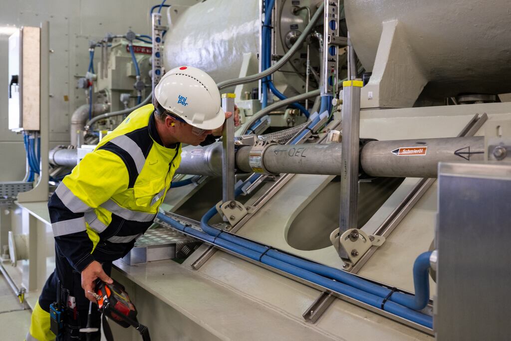 An employee of Uniper Energy Storage inspects the above-ground facilities of a natural gas storage facility at the Uniper Energy Storage facility in Bierwang, southern Germany on June 10, 2022. (Photo by LENNART PREISS / AFP) (Photo by LENNART PREISS/AFP via Getty Images)