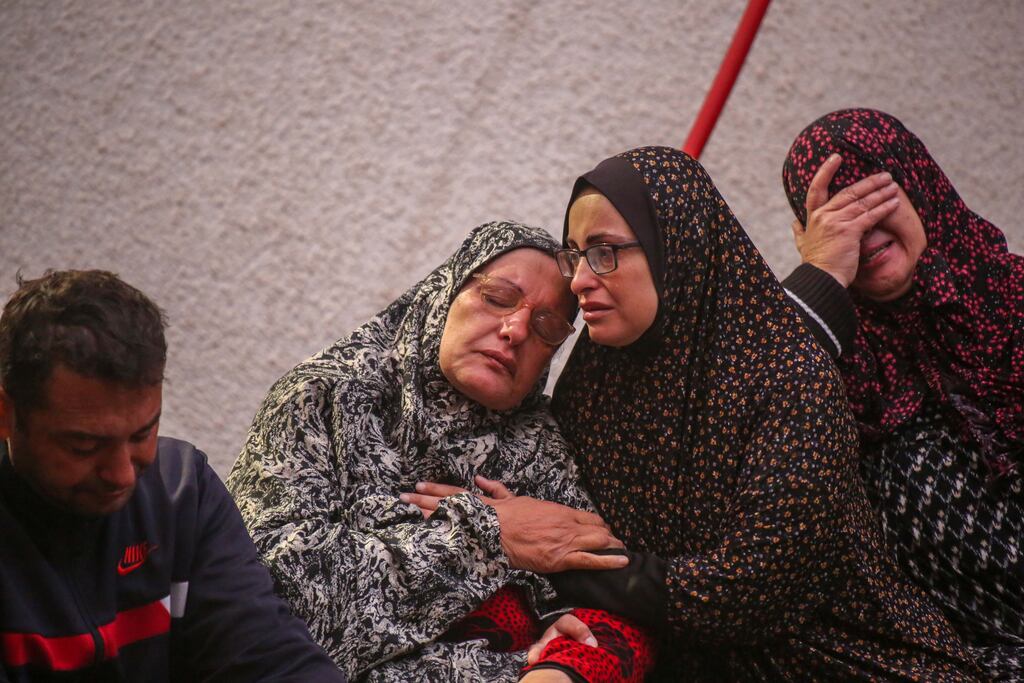 Palestinians waiting to collect the bodies of friends and relatives killed in an air strike in Rafah, Gaza, on Thursday. Photograph: Ahmad Hasaballah/Getty Images