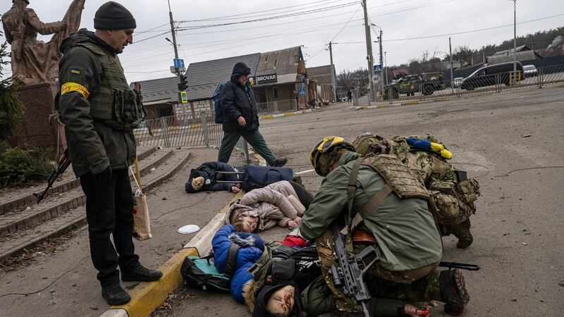 The bodies of Tetiana Perebyinis (43) and her two children, Mykyta (18) and Alisa (9), along with a church volunteer who was helping them, Anatoly Berezhnyi (26) in their town of Irpin, near Kyiv last Sunday. Photograph: Lynsey Addario/The New York Times