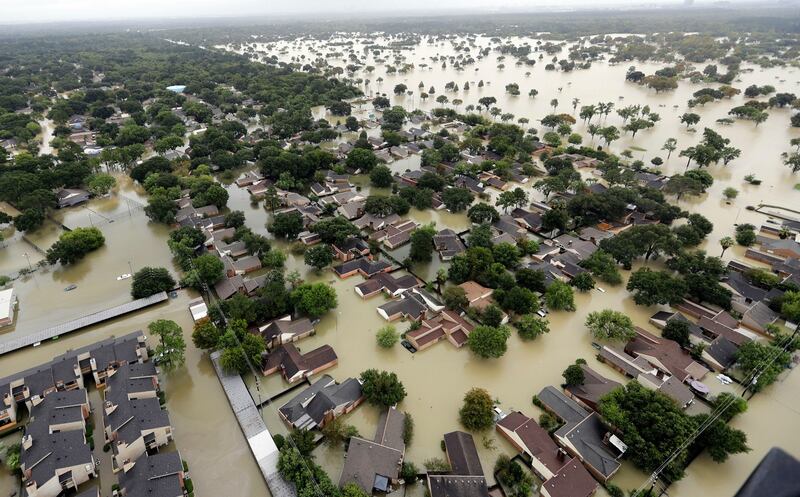 Water from Addicks reservoir flows into neighbourhoods as floodwaters from Tropical Storm Harvey rise in Houston, Texas. Photograph: David J Phillip/AP