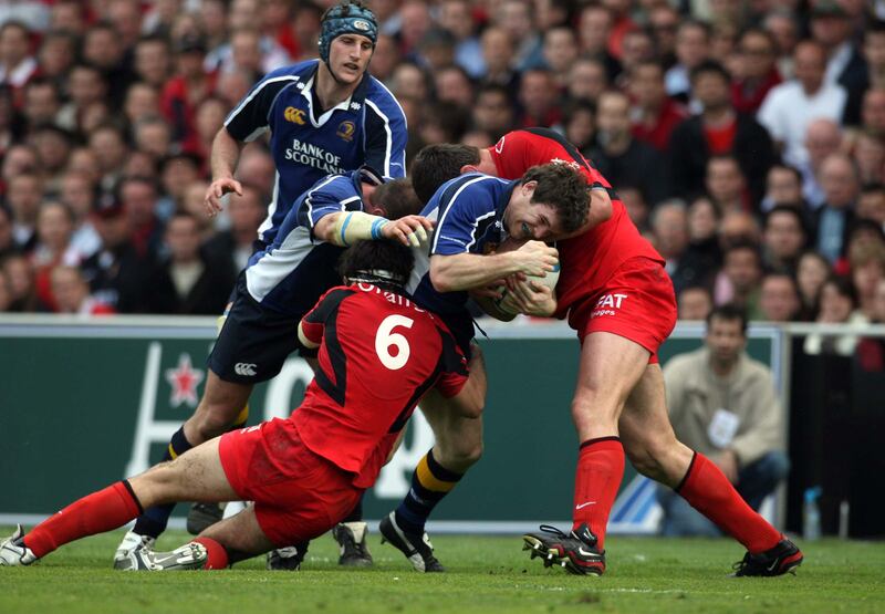 Leinster' Gordon D'Arcy is tackled as he trys to break through the Toulouse defence. Photograph: Billy Stickland/Inpho
