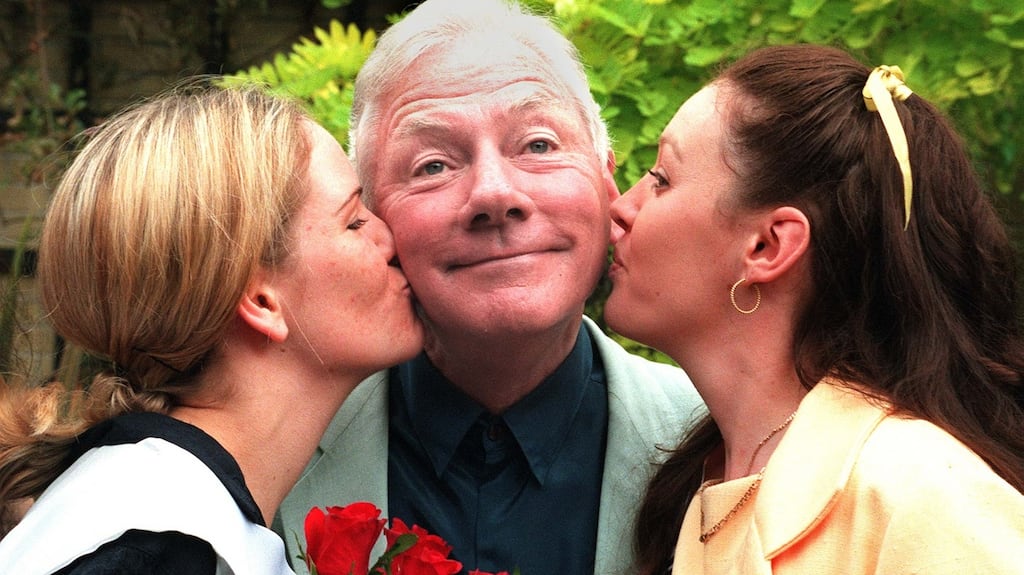 Gay Byrne, who hosted the Rose of Tralee for many years, receives kisses from Melbourne Rose Emily Elliott and South Australia Rose Kim Lambert at a reception in Dublin in 2003. Photograph: Paddy Whelan