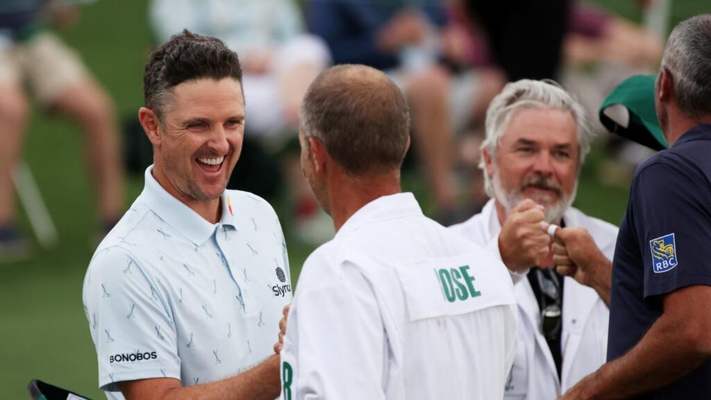 Justin Rose celebrates with his caddie David Clark after his opening round of 65 in the US Masters. Photograph: Kevin C Cox/Getty