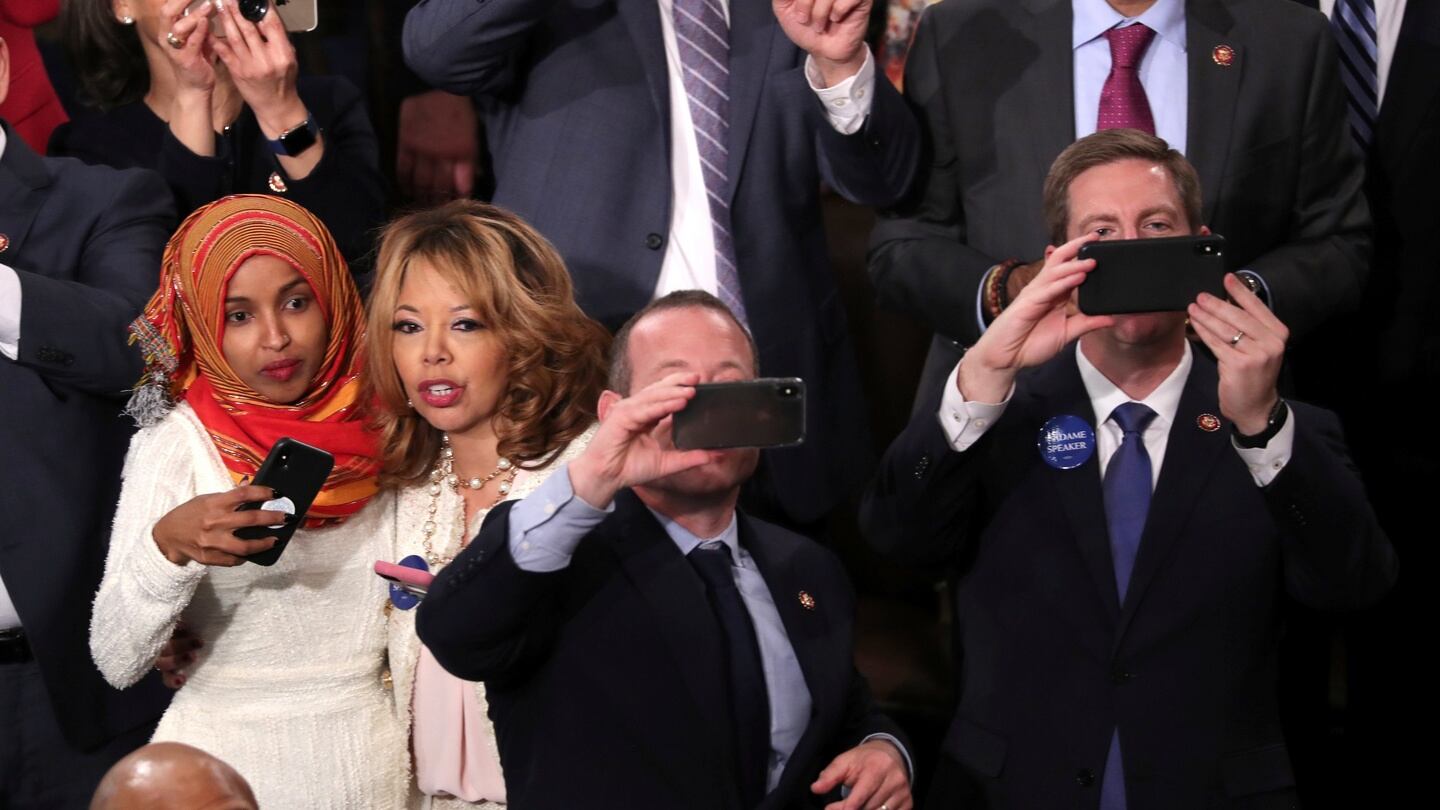 Minnesota Democrat Ilhan Omar (far left) takes pictures of children as they surround speaker Nancy Pelosi in the US House of Representatives on Thursday. Photograph: Jonathan Ernst/Reuters