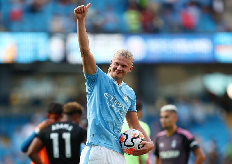 Erling Haaland of Manchester City gives a thumbs up to fans at full time holding his hat-trick ball. Photograph: Matt McNulty/Getty