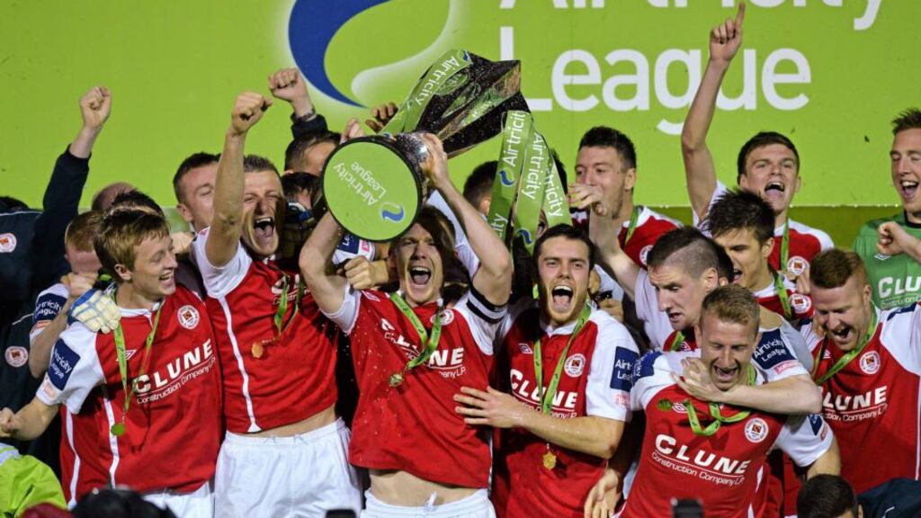 St Patrick’s Athletic captain Conor Kenna lifts the Airtricity League Premier Division trophy alongside his team-mates at Richmond Park. Photograph: Sportsfile