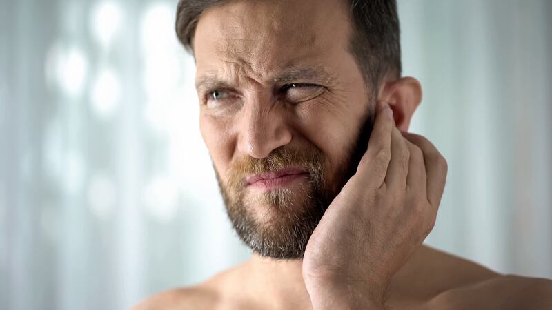 Pain inside the ear, a high temperature, a feeling of pressure or fullness inside the ear, and difficulty hearing, are common symptoms of ear infection in adults. Photograph: iStock
