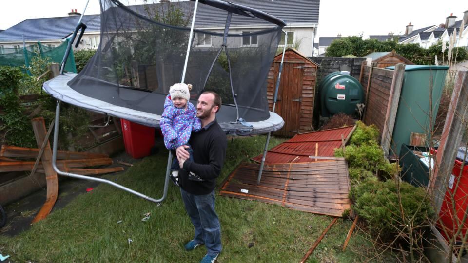 Malachy Duggan with his two year old daughter Easkey with the trampoline which appeared in his back garden yesterday at Binn Bhan, Knocknacarra, Galway, after the storm. Photograph: Joe O’Shaughnessy
