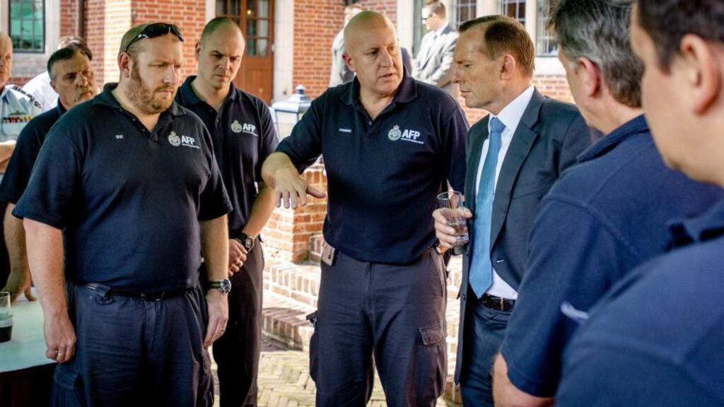 Australian prime minister Tony Abbott (third from right) speaks to Australian forensic researchers during a visit yesterday to the Korporaal Van Oudheusden barracks in Hilversum, in the Netherlands, the location where the victims of flight MH17 are being identified. Photograph: EPA/Robin van Lonkhuijsen