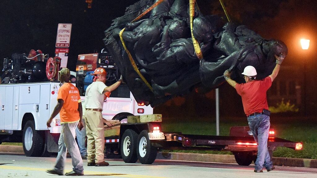 Workers remove a monument dedicated to the Confederate Women of Maryland early on Wednesday in Baltimore, Maryland. Photograph: Jerry Jackson/The Baltimore Sun via AP