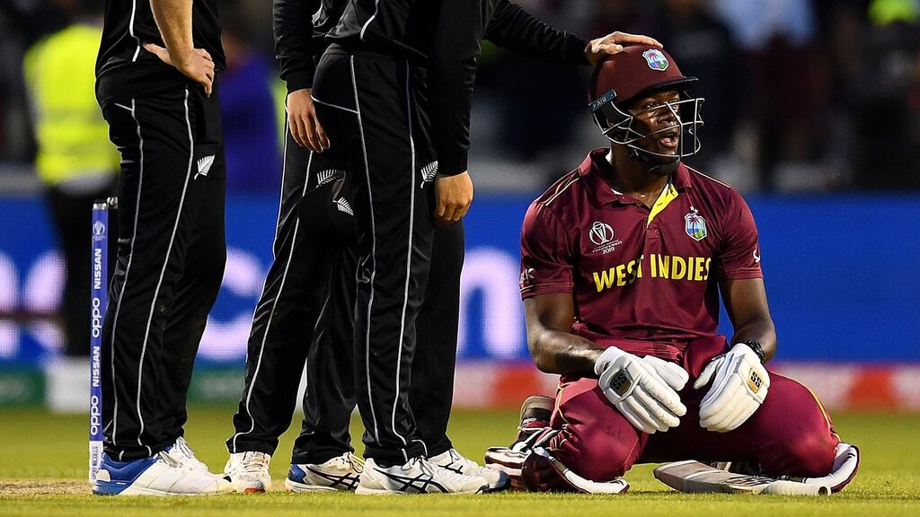 Carlos Brathwaite of West Indies is consoled by New Zealand players after he was caught on the boundary to end the World Cup game at Old Trafford. Photograph: Clive Mason/Getty Images
