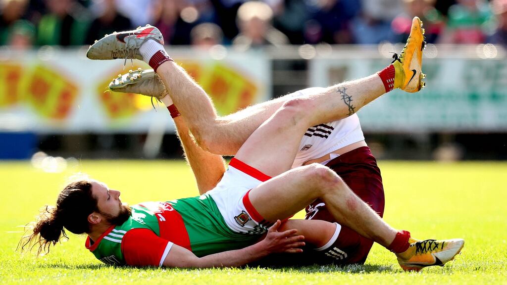 Mayo’s Padraig O’Hora lands on Galway’s Matthew Tierney in Sunday’s Connacht championship clash. Photograph: Ryan Byrne/Inpho
