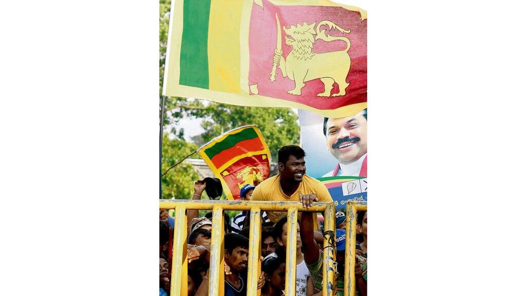 Supporters of incumbent President Mahinda Rajapaksa celebrate near the Election High Commission in Colombo yesterday, after he won a second term in office. Photograph: Dinuka Liyanawatte/Reuters
