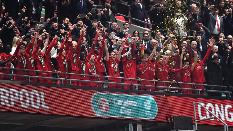 Liverpool captain Jordan Henderson lifts the League Cup. Photograph: Michael Regan/Getty Images
