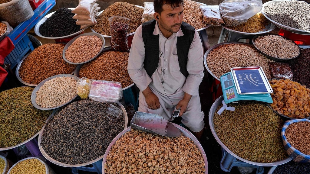 A roadside vendor selling dry fruits waits for customers at a market area in Kabul. Photograph: Hoshang Hashimi/AFP via Getty Images