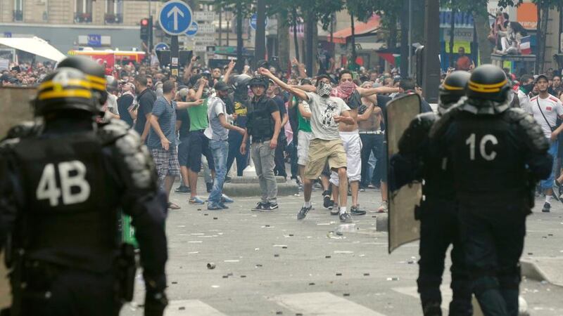 Pro-Palestinian protesters throw projectiles in Paris today during a demonstration against violence in the Gaza strip which had been banned by police. Photograph: Philippe Wojazer/Reuters.