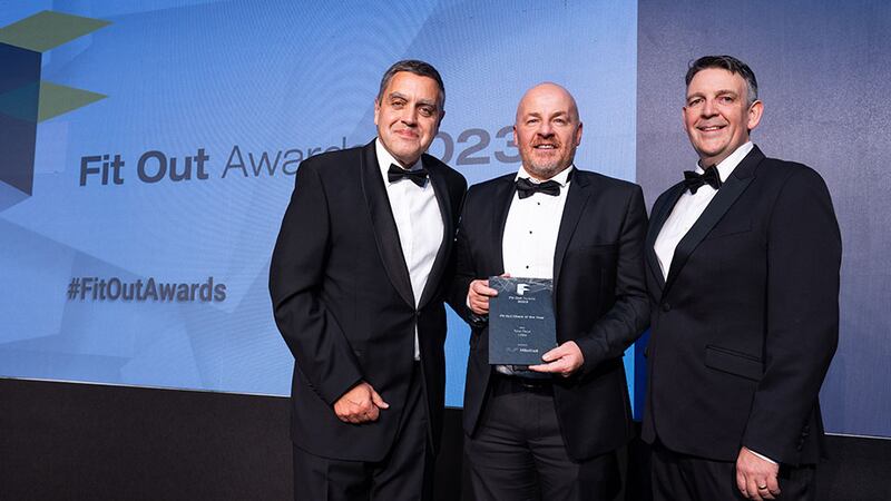 Nikos Liapis, regional director at Millerknoll, presents the fit out client of the year award to Richard Gray and Shea Woods, Total Fitout