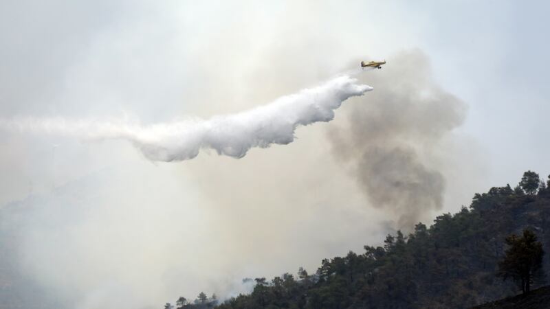 A Canadair plane flies over the forest fire in the Larnaca mountain region, Cyprus. Photograph: Katia Christodoulou/EPA