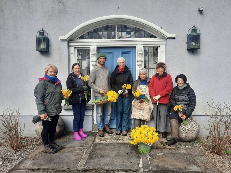 The gardens are maintained by volunteers, pictured here in spring with head gardener Paul Smyth outside the front door and fanlight with some of the daffodil varieties