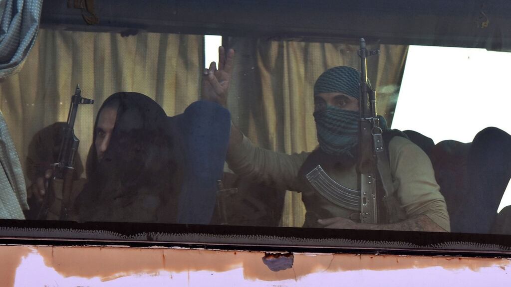 Syrian opposition fighters and members of their families from the Yarmouk camp, on the outskirts of Damascus, arrive at the al-Eis checkpoint in Aleppo province on Tuesday. Photograph: George Ourfalian/AFP/Getty Images