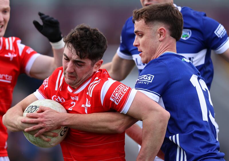 Niall Corbet of Laois tackling Emmet Carolan of Louth. Photograph: Leah Scholes/Inpho