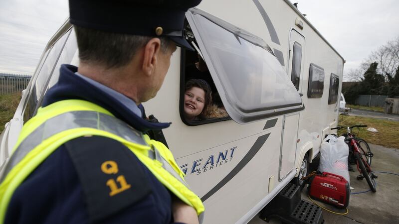 A garda speaks to a child at the halting site on the Balgaddy Road, Clondalkin in January. Photograph Nick Bradshaw