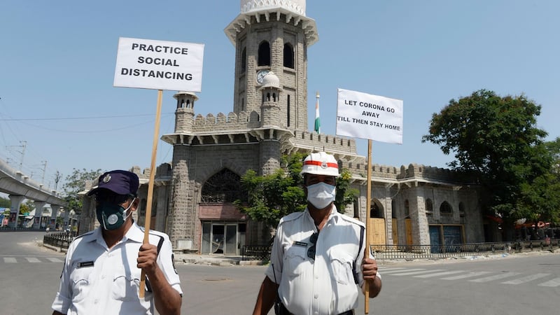 Traffic police personnel hold placards on a deserted road during a one-day nationwide Janata (civil) curfew imposed as a preventive measure against the Covid-19 coronavirus, in Hyderabad on Sunday. Photograph: Noah Seelam/AFP/Getty Images