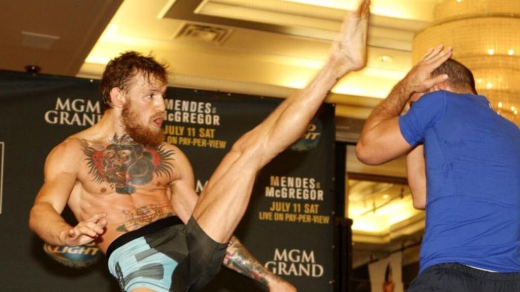 Conor McGregor, who fights for the interim UFC featherweight title against Chad Mendes in Las Vegas, throws a high kick during his open workout session in the MGM Grand. Photograph: Getty Images