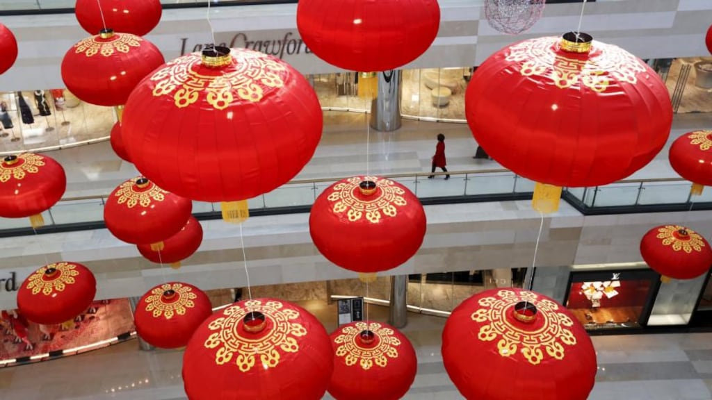 A shopper is seen through large lantern decorations at a shopping mall in Beijing. Capital growth is falling after a huge investment boom in the 2000s, particularly in China. Photograph: Kim Kyung-Hoon/Reuters