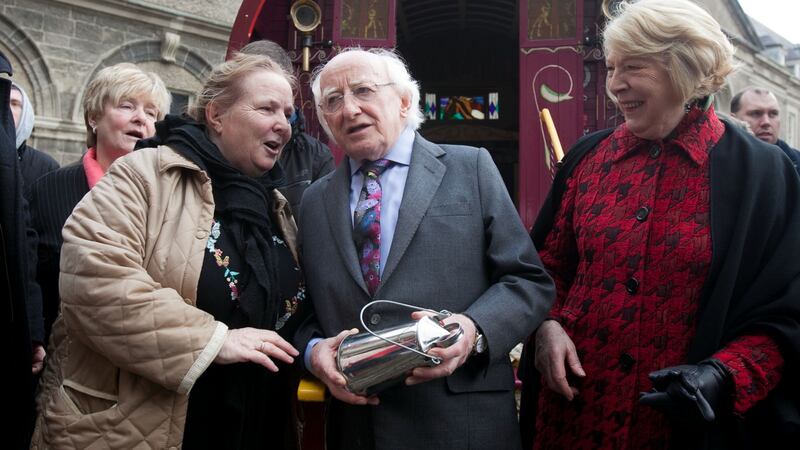Ellen McDonagh from Navan presents President of Ireland Michael D Higgins and Sabina Higgins with a miniature churn can created by a traditional tin smith during the Irish Traveller Ethnicity Celebration at the Royal Hospital Kilmainham, Dublin. Photograph: Gareth Chaney Collins