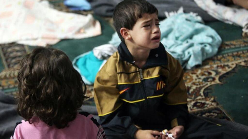 A boy who survived what activists say is a gas attack cries as he takes shelter inside a mosque in the Duma neighbourhood of Damascus yesterday. Photograph: Mohamed Abdullah/Reuters