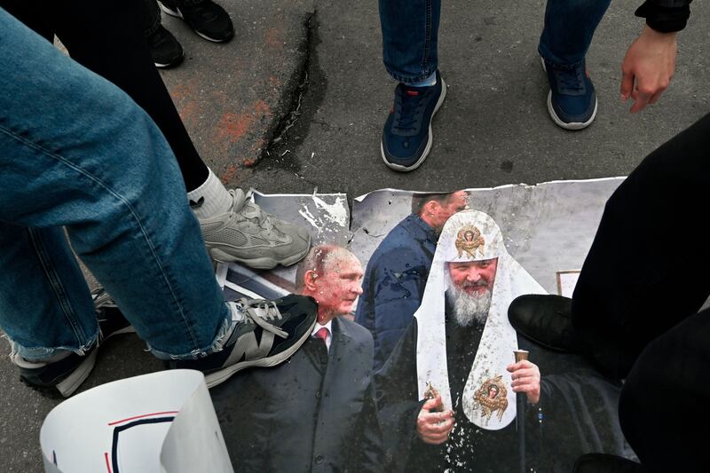 Pro-Ukrainian activists trample a photo of Russian president Vladimir Putin and Patriarch of Moscow and All Russia Kirill outside the historic Kyiv-Pechersk Lavra monastery in Kyiv, on Saturday. Photograph: Sergei Chuzavkov/AFP/Getty