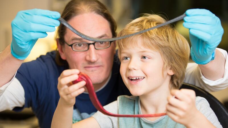 Prof Jonathan Coleman and his son Oisín with silly putty infused with graphene. Photograph: Naoise Culhane