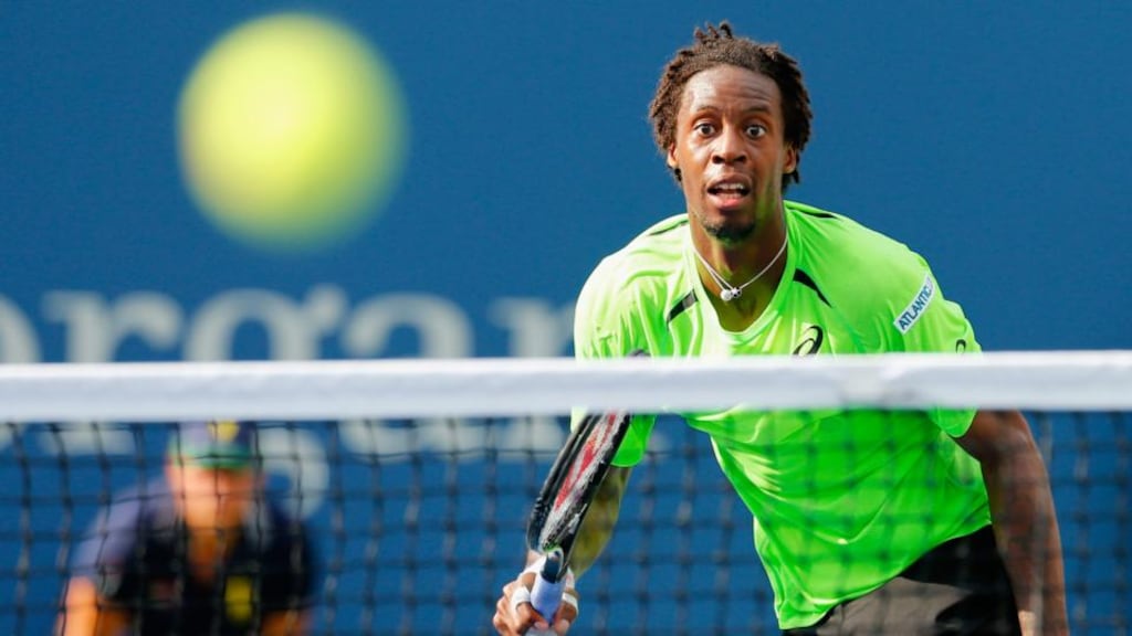 Gael Monfils of France returns a shot against Grigor Dimitrov of Bulgaria in their men’s singles fourth round match   at the US Open.