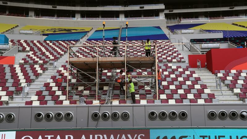 Workers prepare the Khalifa International Stadium where the giant air conditioning vents can be seen. Photo: Mike Egerton/PA Wire