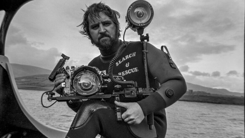 Photojournalist Ronan Quinlan on location in Dingle to take photos of Fungie. Photograph: Ronan Quinlan