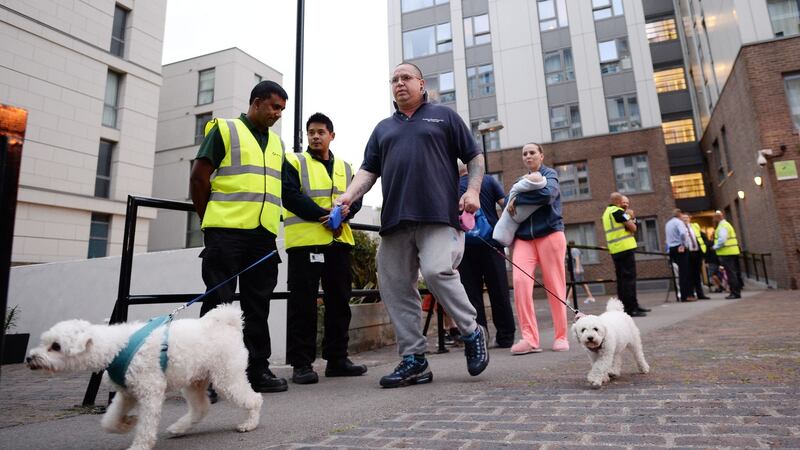 Residents leave a tower block on the Chalcots Estate in Camden, London, as the building is evacuated in the wake of the Grenfell Tower fire to allow “urgent fire safety works” to take place. Photograph: Stefan Rousseau/PA Wire