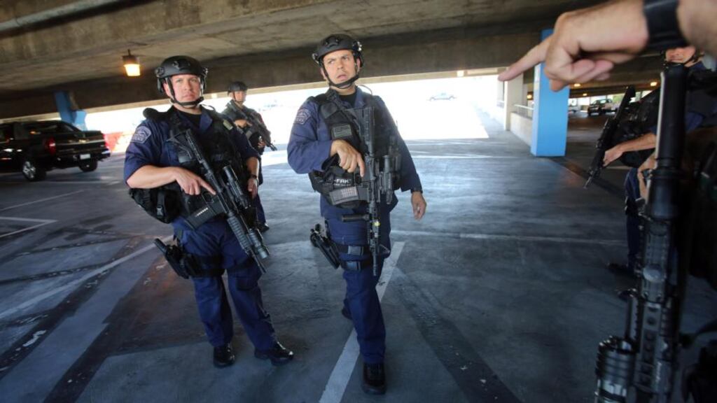 SWAT officers search a parking structure during a security check at Los Angeles International Airport