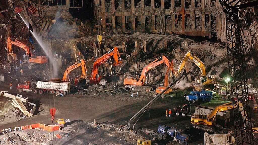 Workers and heavy machinery in the cleanup and recovery effort in front of what remained of 1 World Trade Center at ground zero in New York. Photograph: AP
