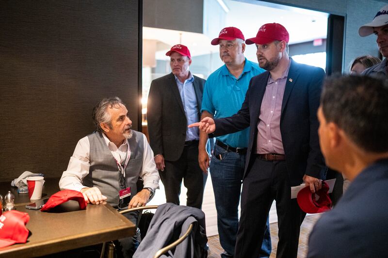 Brett Eagleson, right, president of 9/11 Justice and son of John Bruce Eagleson, who was killed in the South Tower of the World Trade Center, speaks in July 2022 with David Feherty, who is a broadcaster for the Saudi-funded LIV Golf Invitational Series. Photograph: Doug Mills/The New York Times