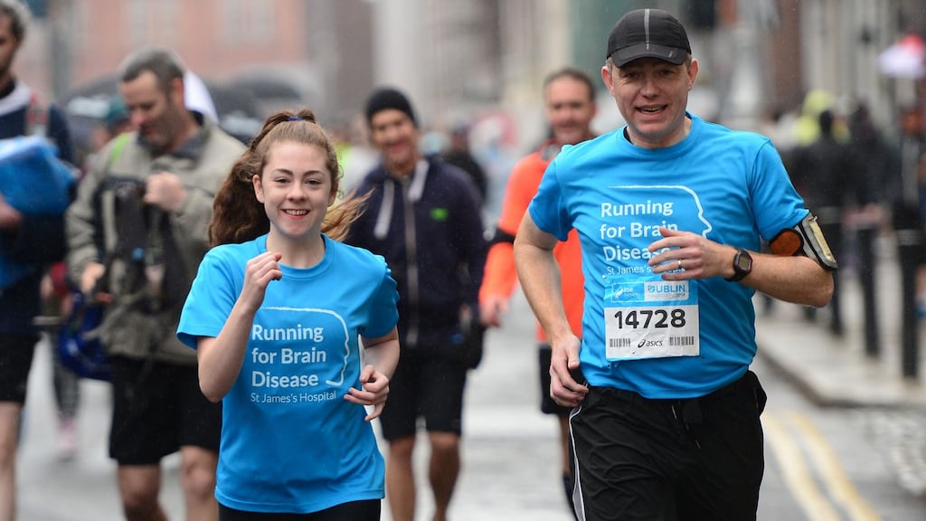 Katie Cooke runs with Dr Colin Doherty at the start of the SSE Airtricity Dublin Marathon on October 26th. Photograph: Dara Mac Dónaill