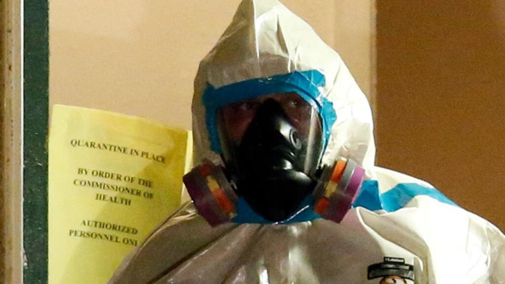 A worker in a hazardous-material (hazmat) suit at a block in Dallas, Texas, where a man diagnosed with Ebola was staying. Photograph: Jim Young/Reuters