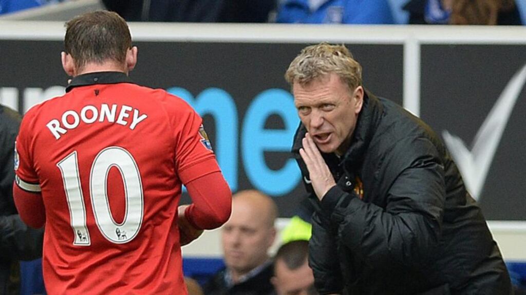 Manchester United manager David Moyes speaking to Wayne Rooney during their clash with Everton. Photograph: Peter Powell/EPA
