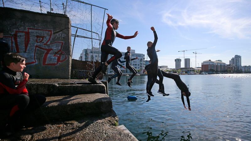Dublin city swimmers jump into the river Liffey at the city docks. Photograph: Nick Bradshaw