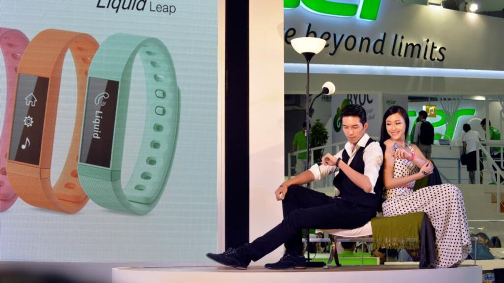 Models with the Acer Liquid Leap smartwatch at the Taipei Computex Taipei 2014 expo: Taiwan is looking to China for growth and its larger neighbour accounts for one-third of all smartphones sold worldwide this year. photograph: chris stowers/bloomberg