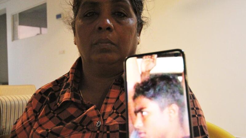 Jayakumari Balendran, an activist for the civil war’s missing, displays a picture of her son Mahinthan (15). Photograph: Tom Farrell