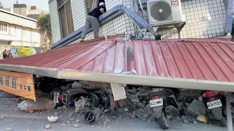 A man checks a partially collapsed building in Hualien, eastern Taiwan following Wednesday's earthquake. Photograph: TVBS via AP
